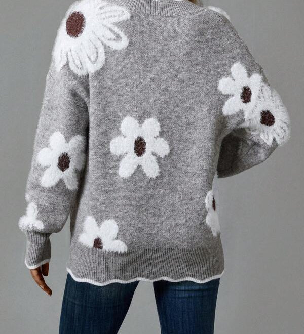 Gray knit sweater with large floral motifs on the back and ribbed hem
