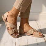 Beige orthopedic slide sandals with twisted crossover strap and ankle chain, open toe