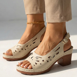 White orthopedic slide sandals with perforated cutout straps and wooden block heel