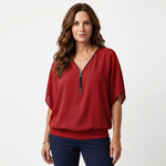 Red zip-front blouse with short dolman sleeves and V-neck placket