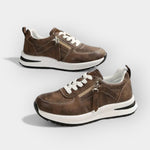Anatomical brown sneakers with white laces, side zipper, and thick white sole.