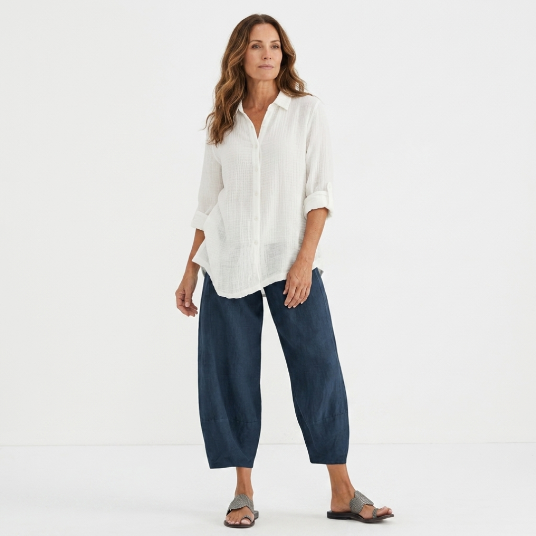 Dark blue lightweight summer pants on model, loose cropped ankle style