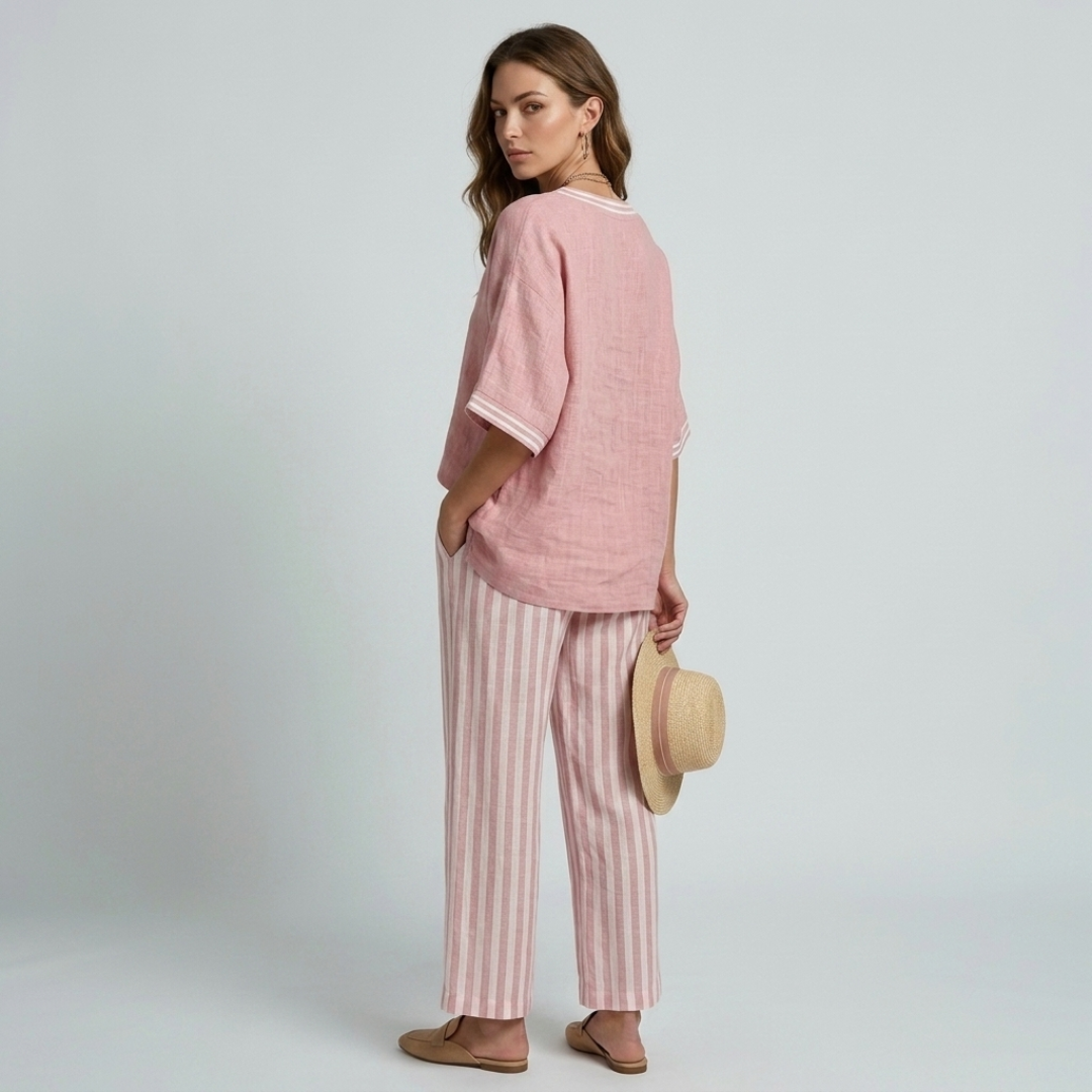 Women's pink V-neck top and striped wide-leg pants, side profile