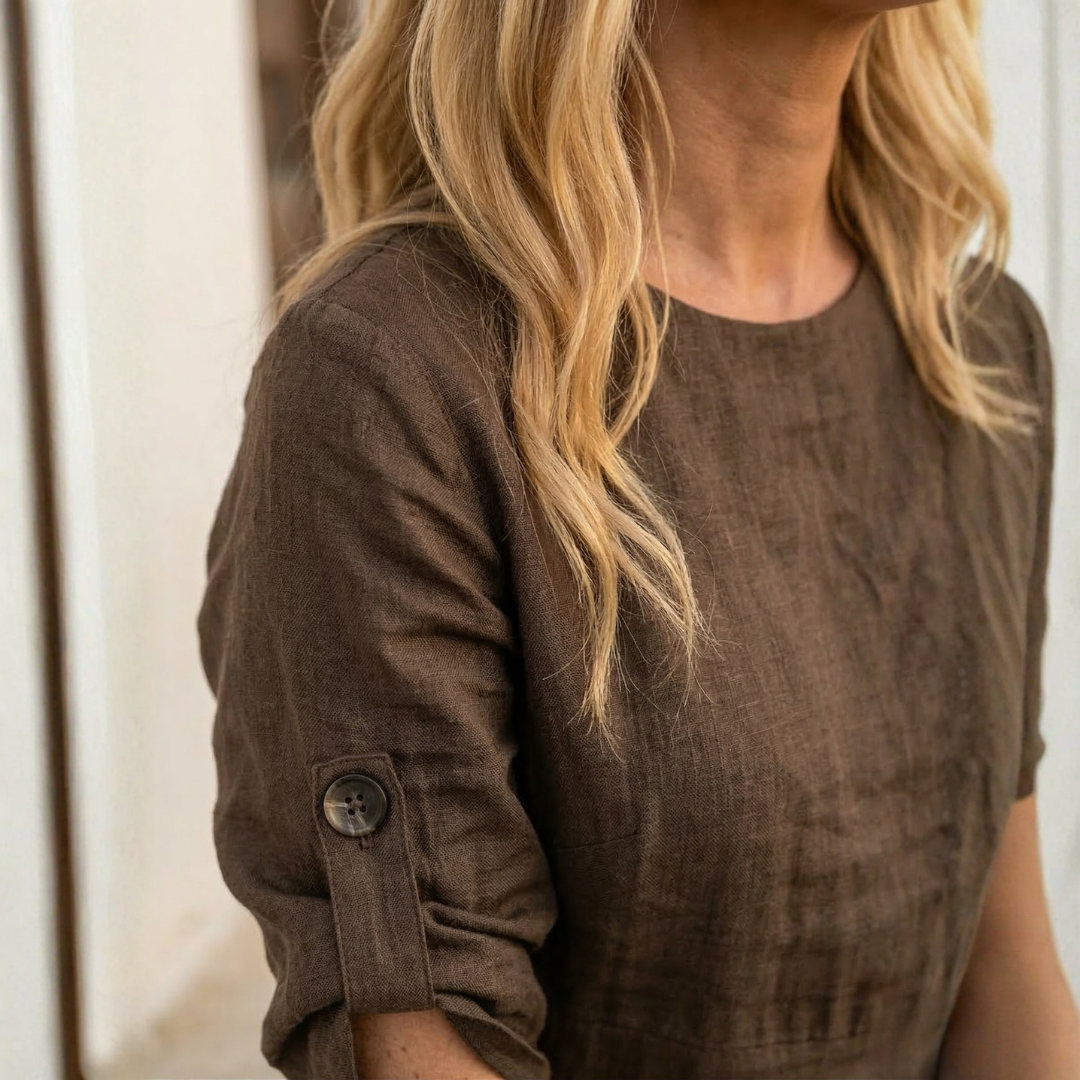 Chestnut dress close-up: buttoned cuff sleeve and round neckline