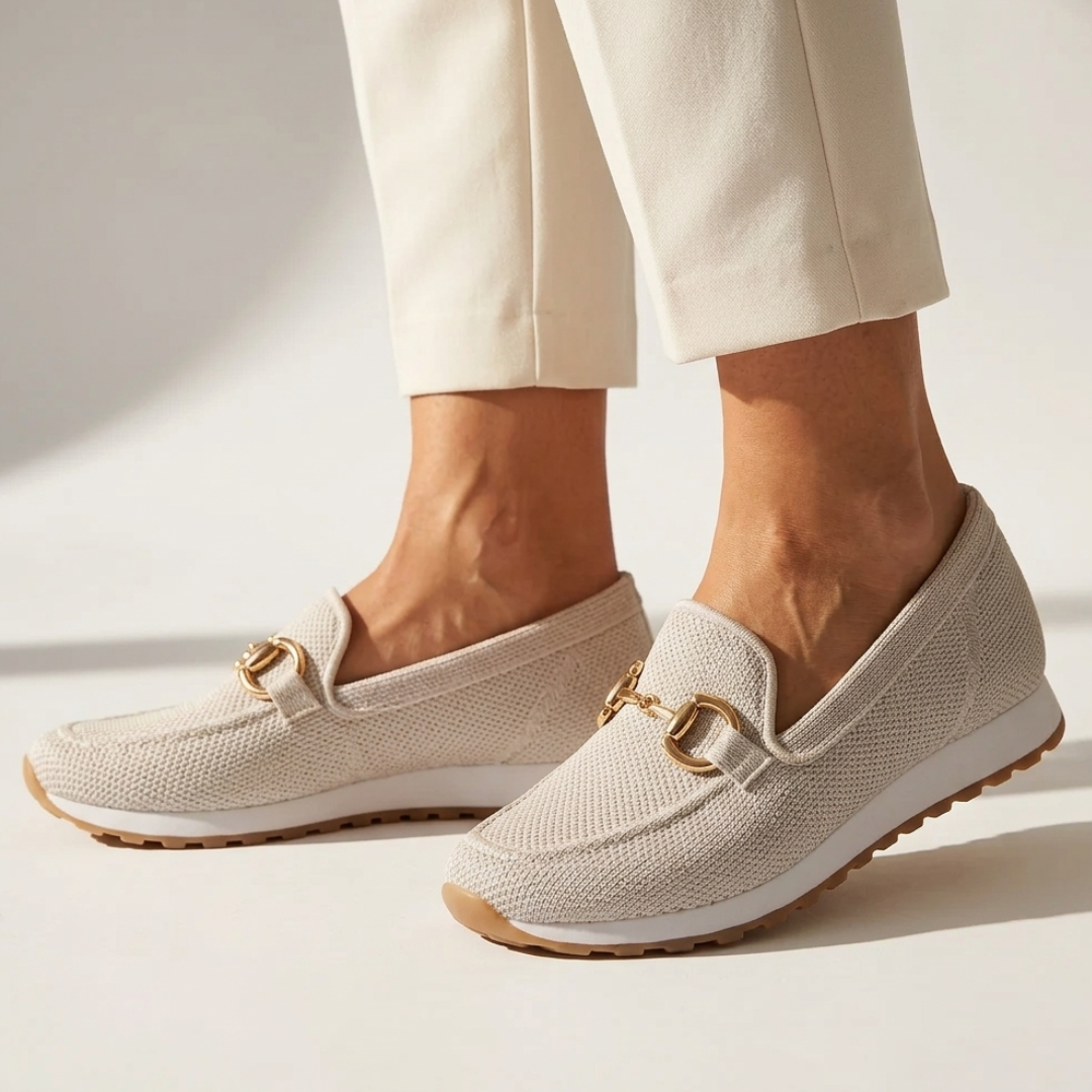 Beige orthopedic moccasin shoes on feet, gold-tone horsebit detail and textured upper