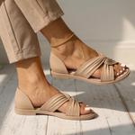 Beige orthopedic slide sandals with knotted front strap and ankle chain, open toe