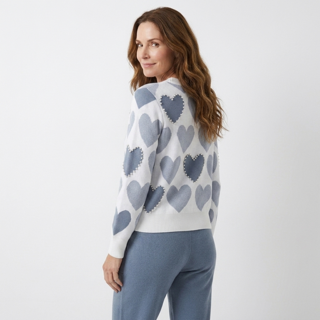 Blue heart-print knit sweater with ribbed cuffs and slate-blue joggers, side view