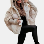 Beige hooded puffer jacket with faux-fur trim and quilted sleeves, ribbed cuff detail