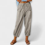 Light gray harem pants with elastic waist and side cargo pockets