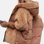 Tan hooded puffer jacket with faux-fur trim and quilted design, front zipper visible