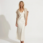 Madalina knit V-neck sweater over white satin midi dress, angled front view