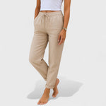 Beige elastic linen jogger pants with drawstring waist and tapered cuffs