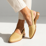 Light tan woven leather summer loafers with round buckle strap and low wooden heel