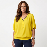 Yellow zip-front blouse with short dolman sleeves and V-neck placket