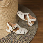 Amaya leather sandals in beige/cream with crisscross straps and metal buckle