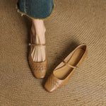 Tan Mary Jane flats with square toe, ankle strap, and woven lattice texture