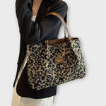 Leopard print canvas shoulder bag with brown leather trim and gold chain handles