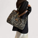 Leopard print tote bag with long gold chain strap and brown leather trim