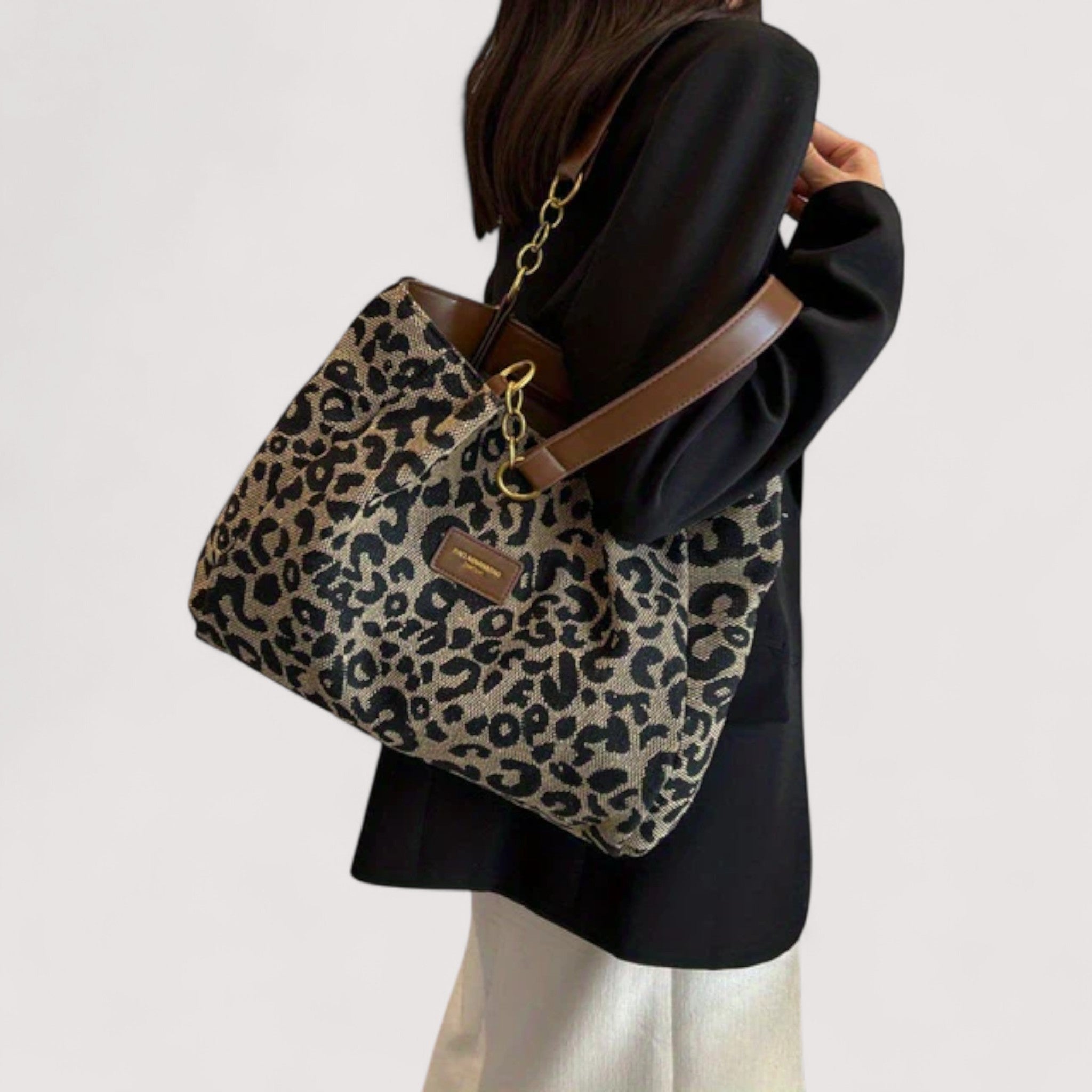 Leopard print tote bag with long gold chain strap and brown leather trim