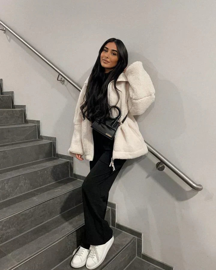 White sherpa zip-up winter jacket with stand collar and two front flap pockets