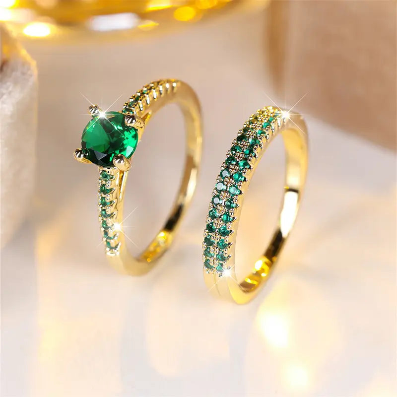 Gold-tone emerald green duo rings: oval center stone and matching green pave band