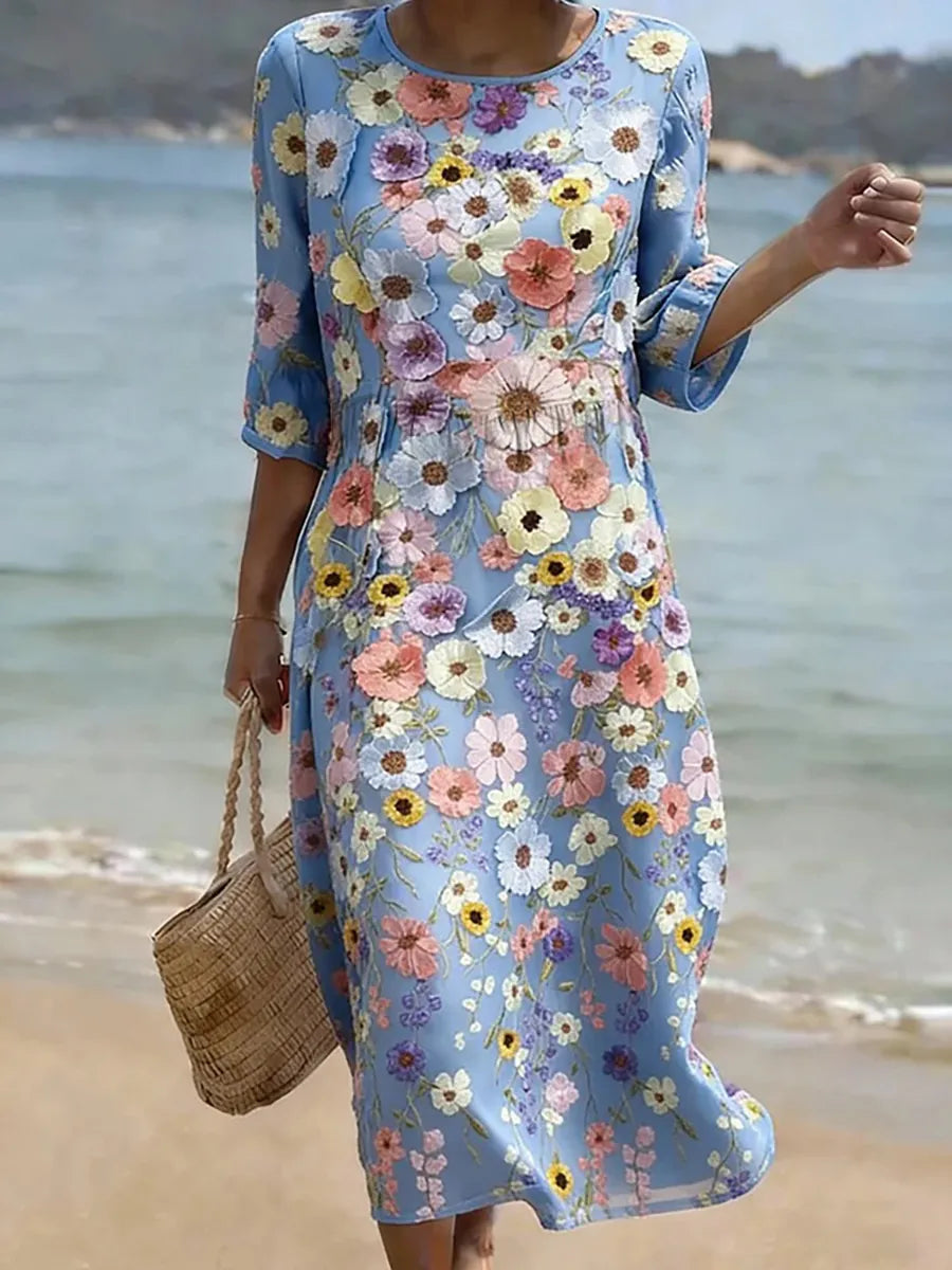 Blue midi dress with colorful floral print, round neckline and 3/4 sleeves