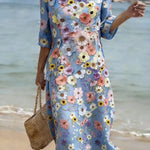 Blue midi dress with colorful floral print, round neckline and 3/4 sleeves