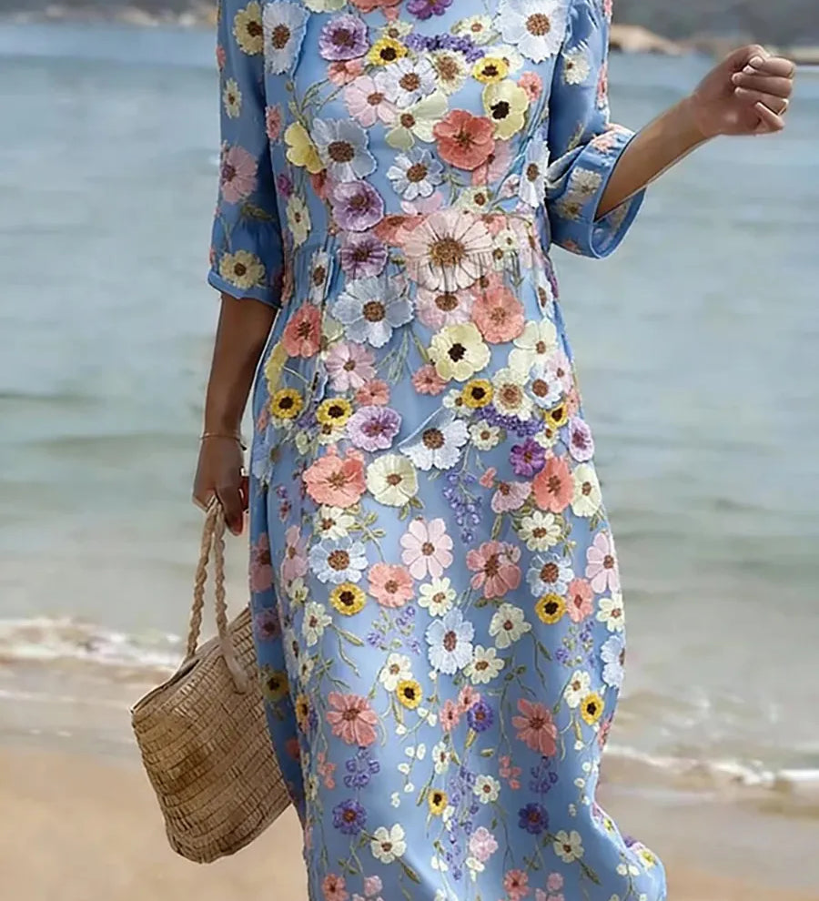 Blue midi dress with colorful floral print, round neckline and 3/4 sleeves