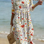 Floral print dress with short sleeves, round neckline, and gathered skirt on white base