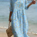 Natalie midi dress in light blue with yellow plant and flower print, round neckline