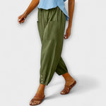 Olive green harem pants with side pockets and button-tab cuffs, relaxed loose fit
