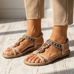 Light beige orthopedic sandals with toe loop straps and decorative charm bead trim