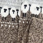 Grey sweater knit close-up with Fair Isle border motif