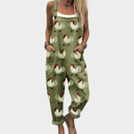 Green loose printed overalls with rooster and rainbow pattern, adjustable straps, bib front