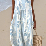 Sleeveless midi dress with blue leafy print, gathered waist