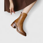 Tan leather ankle boots with side zipper and tassel ties, stacked block heel