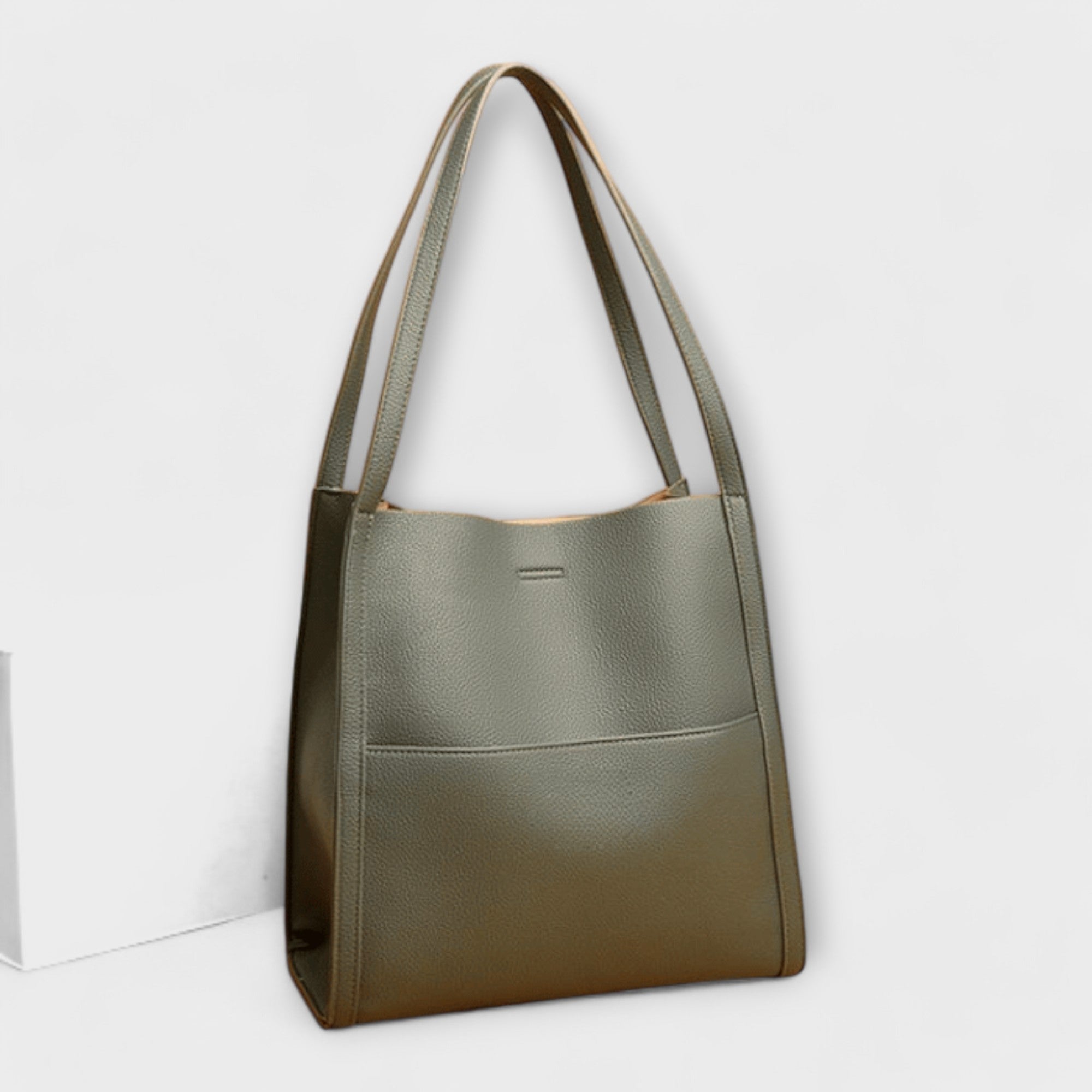 Olive natural leather tote bag with short handles and simple front tab detail