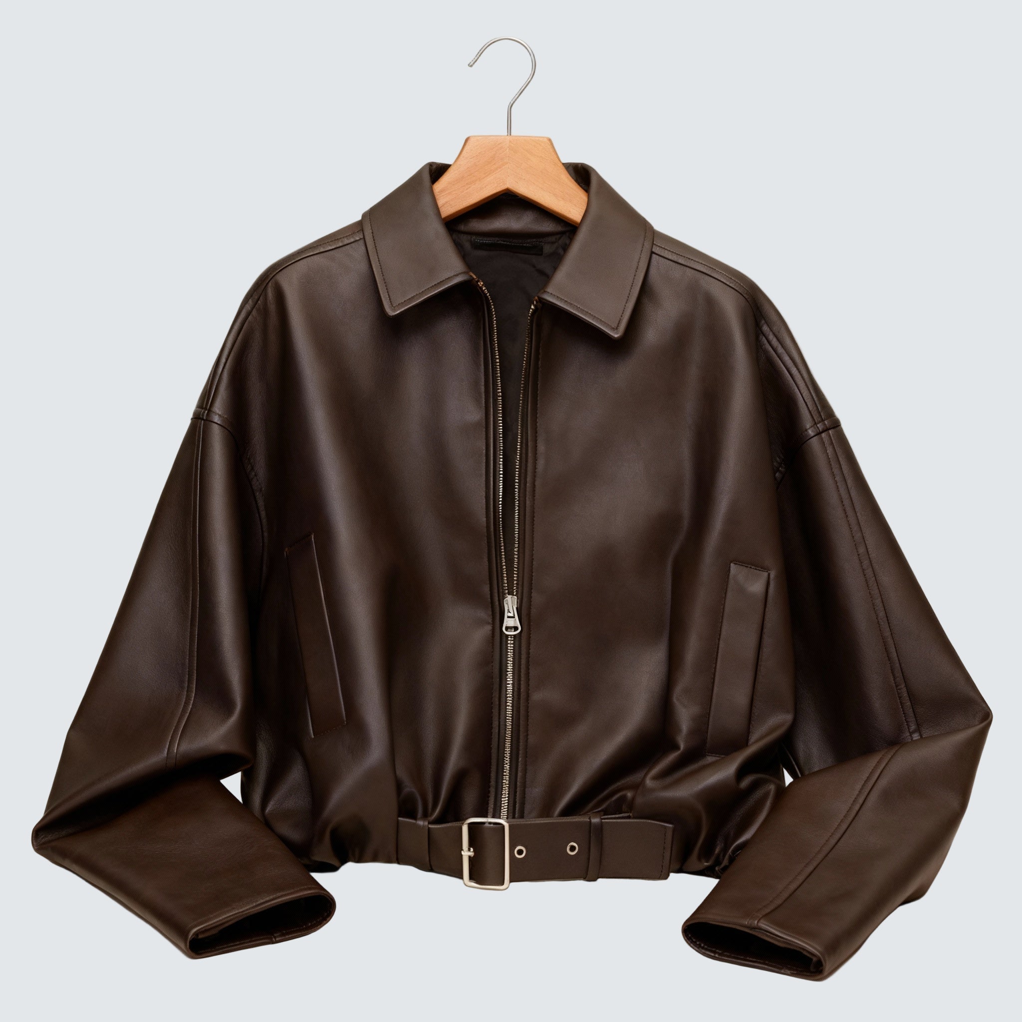 Brown oversized zip-up jacket with pointed collar and snap belt hem