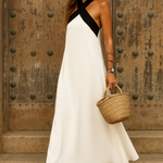 Elegant summer halter dress, white with black diagonal cross strap and flared midi length