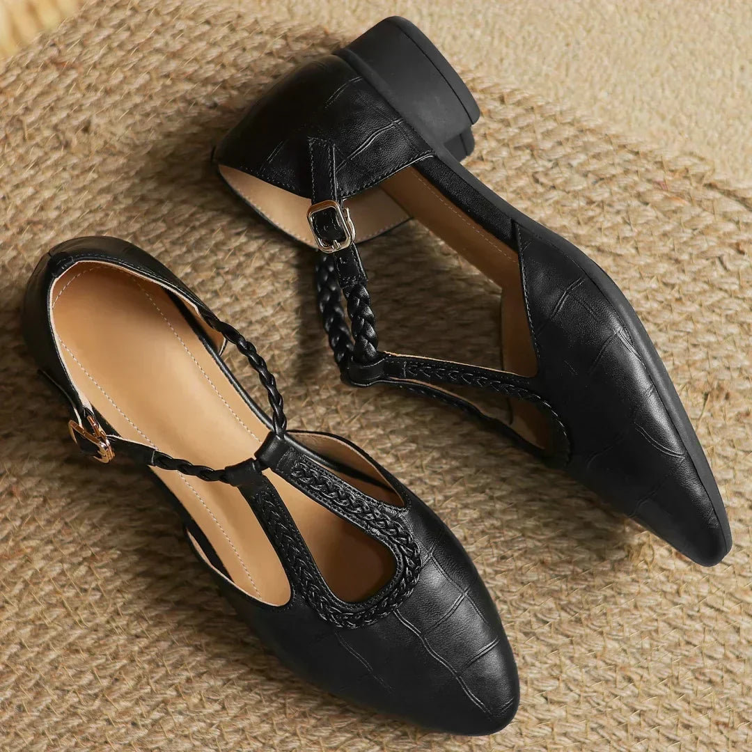 Black leather pointed-toe flats with slingback strap and braided ankle strap