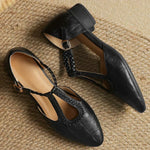 Black leather pointed-toe flats with slingback strap and braided ankle strap