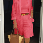 Pink blazer and shorts set with belted waist detail, structured cuff hems.