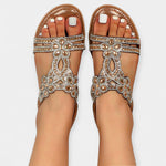 Tan boho sandals with silver rhinestone bow detail and open toe straps