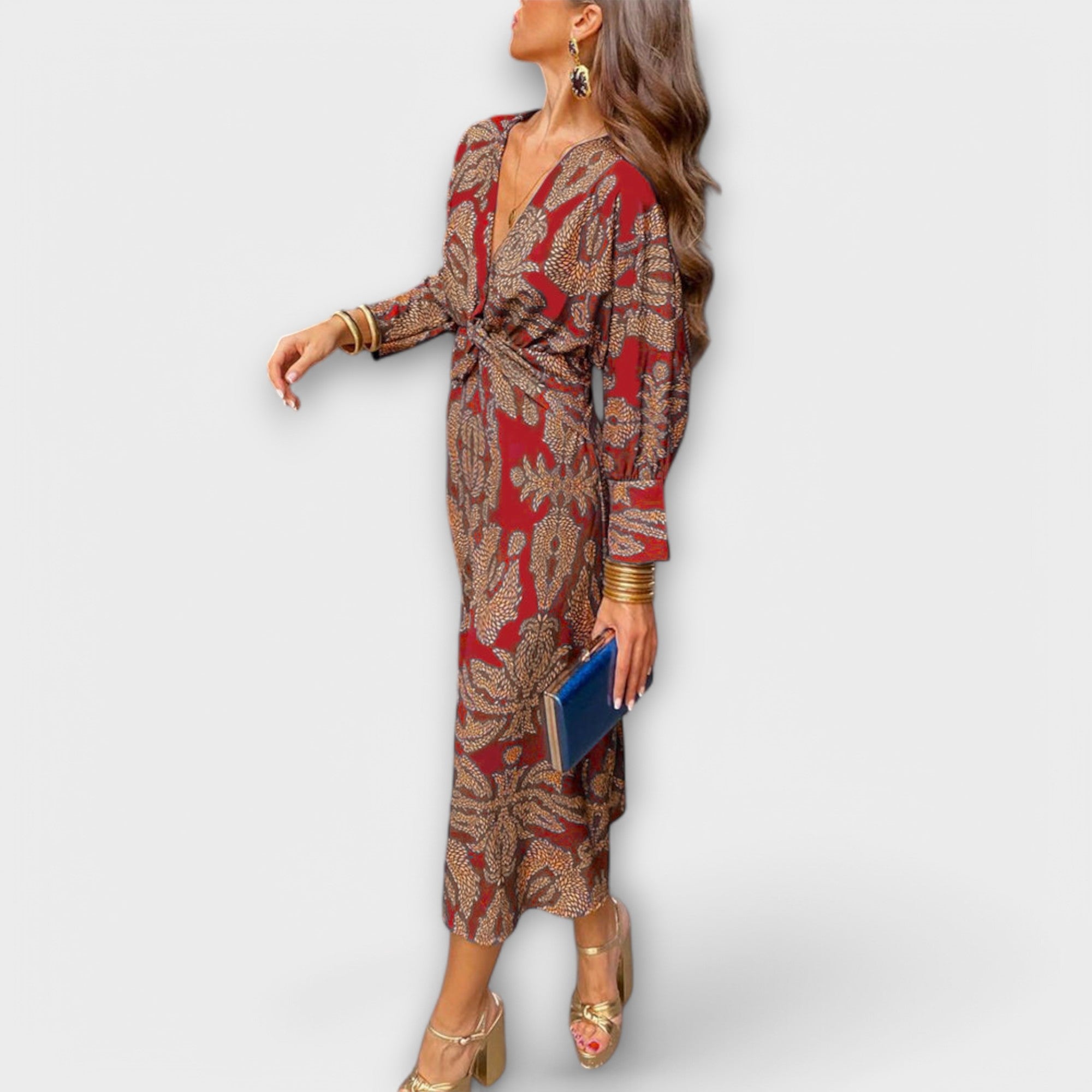 Elegant long-sleeve V-neck dress in red and gold ornate print, waist tie and midi length