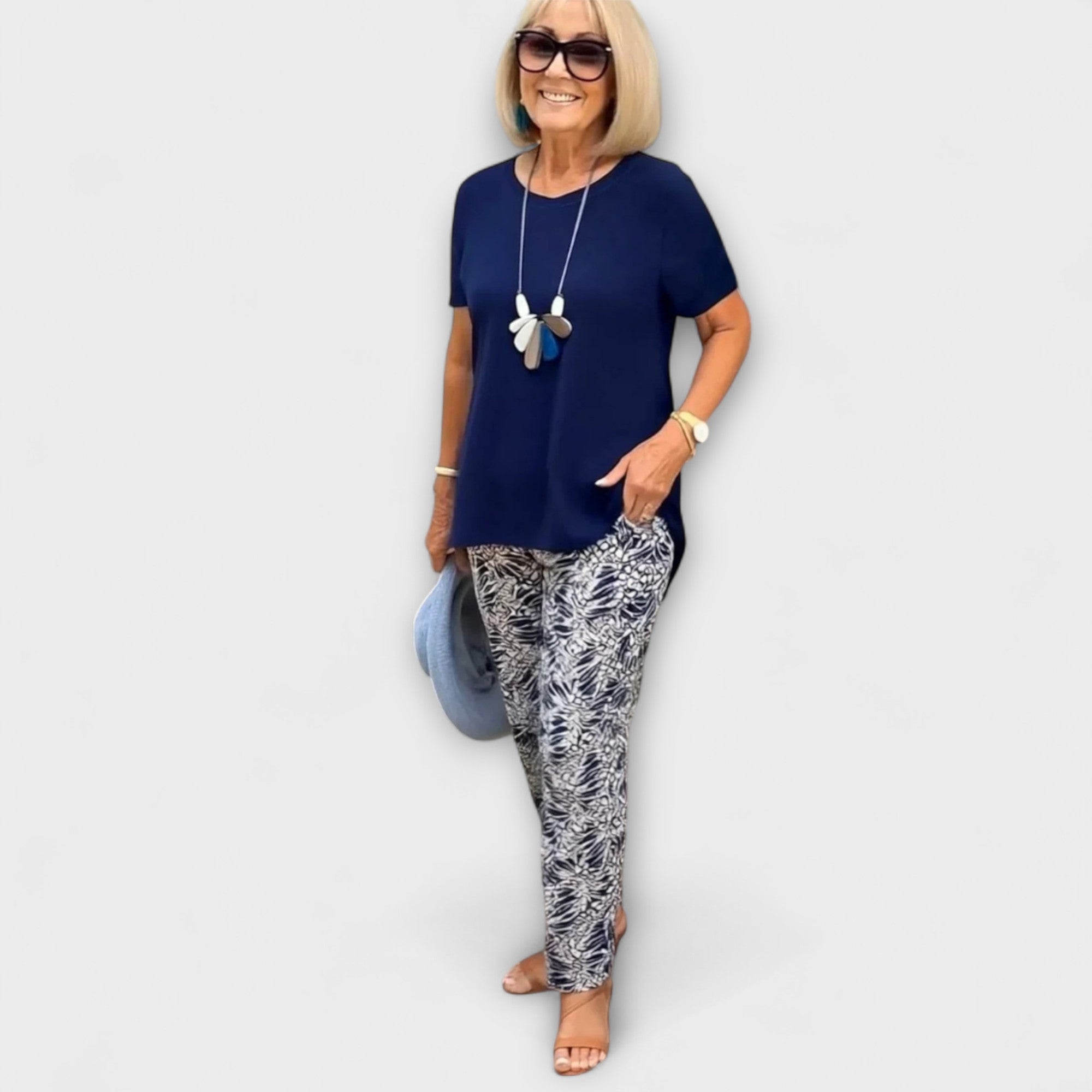 Elegant summer two-piece set: dark blue short-sleeve top and blue-white patterned leggings