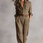 Women’s brown plaid overalls with buttoned collar, long sleeves, and belt