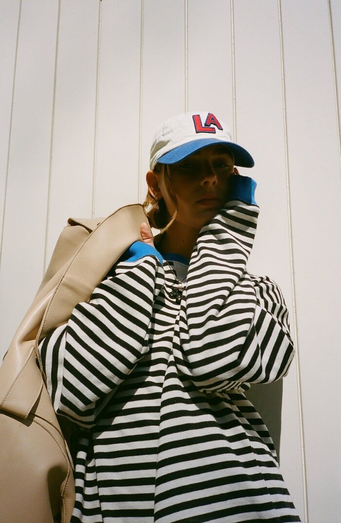 Black and white striped pullover with blue trim at collar and long sleeves