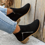 Black suede ankle boots with side zipper and textured block heel, side view.