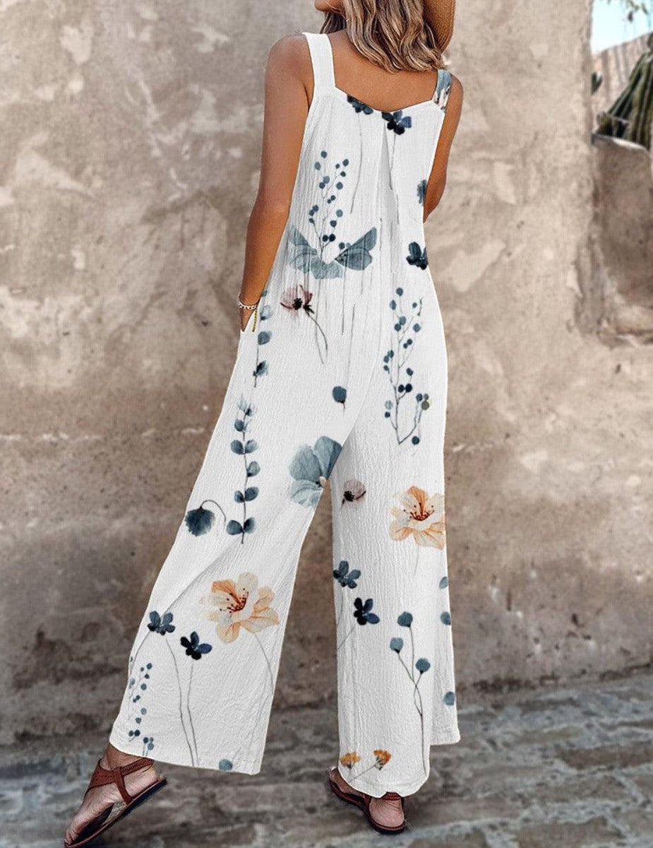Loose printed overalls, sleeveless white floral print with blue leaves and flowers, wide-leg