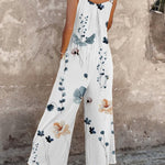 Loose printed overalls, sleeveless white floral print with blue leaves and flowers, wide-leg